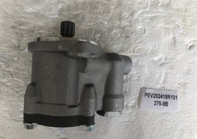A gray motor is hanging on the wall