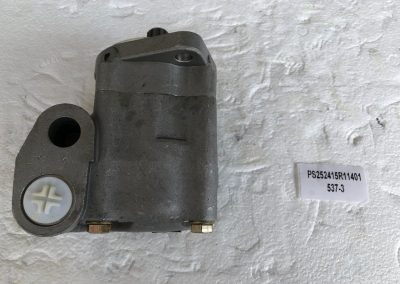 A motor is sitting on the wall with a tag.