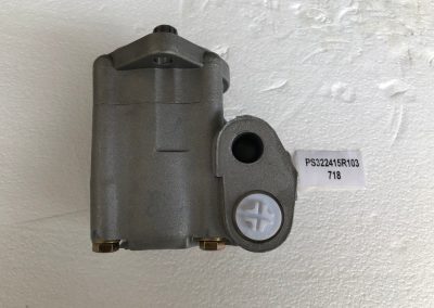 A gray motor on the wall with a sticker